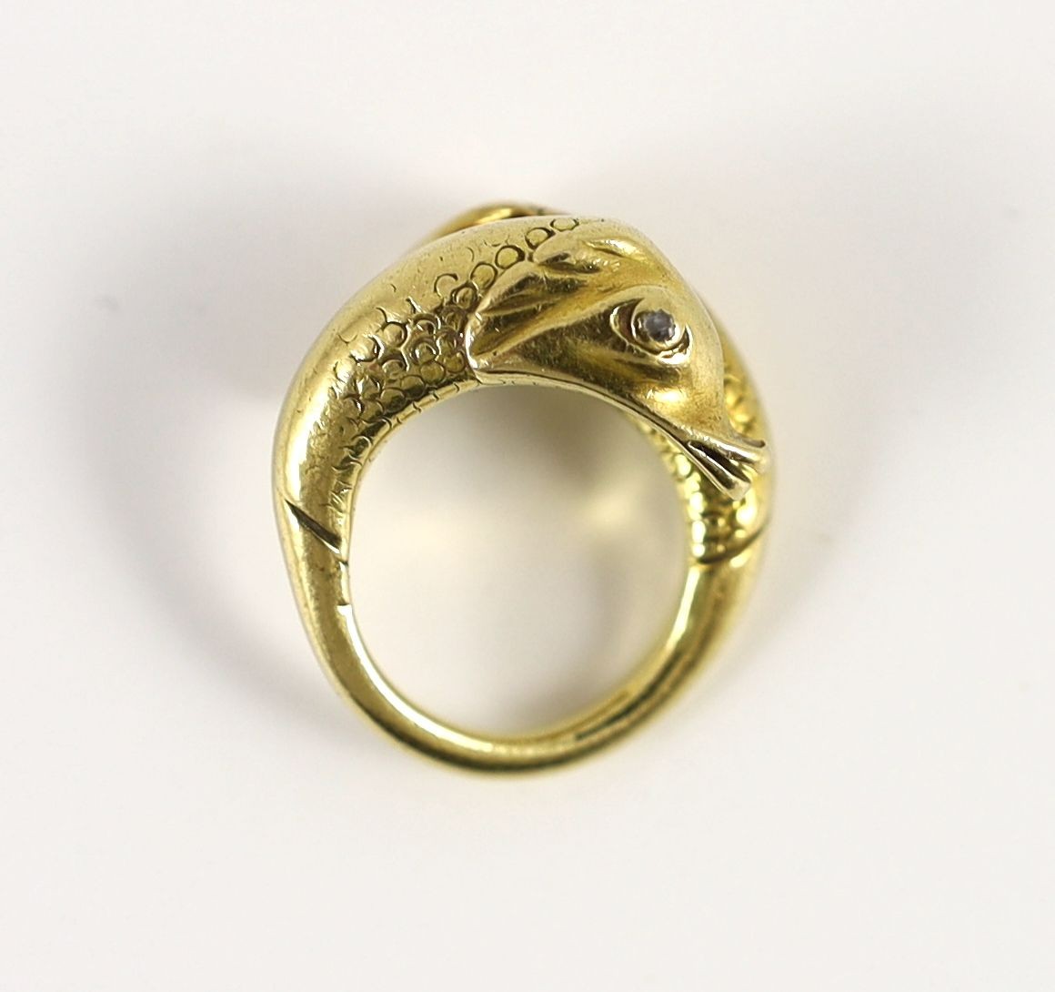 An early 20th century continental gold and diamond chip set twin dolphin crossover ring